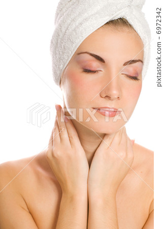 Young lovely lady applying moisturizer to her face after shower Young lovely lady applying moisturizer to her face after shower 6972342