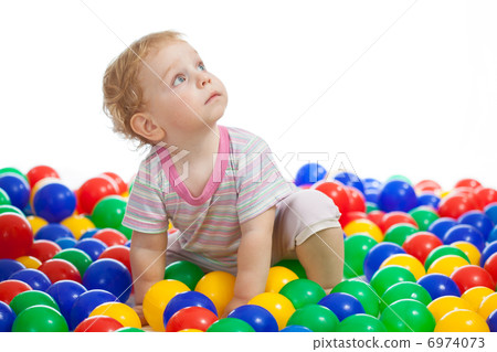 Cute kid or child playing colorful balls looking up 6974073