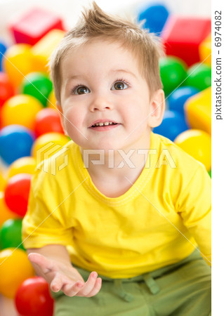 Cute kid or child playing colorful balls top view Cute kid or child playing colorful balls top view 6974082