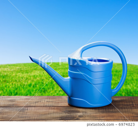 blue watering can to water 6974823