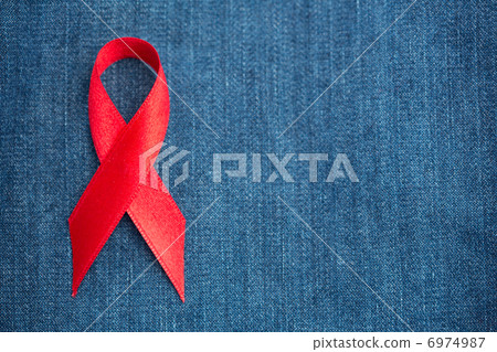 Red ribbon for aids awareness on denim 6974987