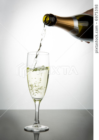 Champagne pouring into flute Champagne pouring into flute 6975398