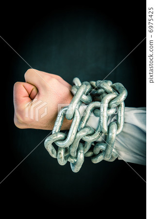 Hands wrapped in chains 6975425