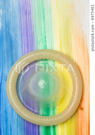 Rolled up condom on rainbow brush stroke Rolled up condom on rainbow brush stroke 6975461