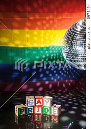 Blocks spelling out gay pride under light of disco ball 6975464