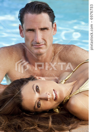 Beautiful Couple Relaxing By Swimming Pool Beautiful Couple Relaxing By Swimming Pool 6976783