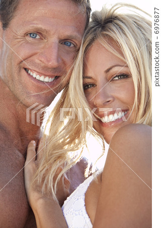 Sexy Attractive Man and Woman Couple Happy At the Beach Sexy Attractive Man and Woman Couple Happy At the Beach 6976877