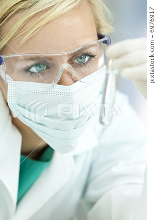 Female Scientist Doctor With Clear Solution Test Tube In Laborat 6976917