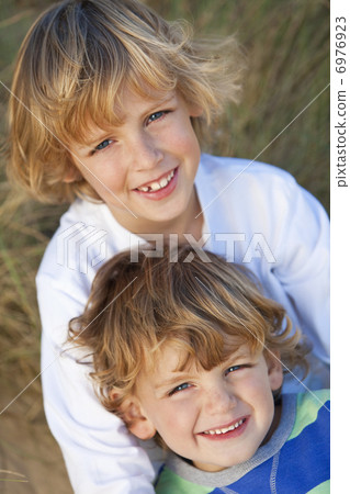 Two Little Boys, Brothers, Together on A Sunny Beach Two Little Boys, Brothers, Together on A Sunny Beach 6976923