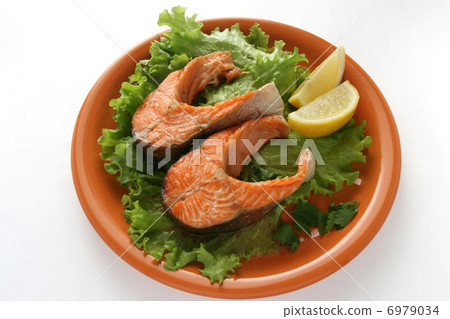 fried salmon on lettuce with lemon fried salmon on lettuce with lemon 6979034