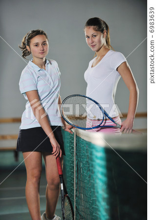 young girls playing tennis game indoor young girls playing tennis game indoor 6983639