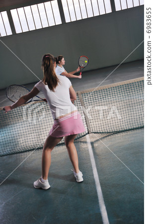young girls playing tennis game indoor young girls playing tennis game indoor 6983655