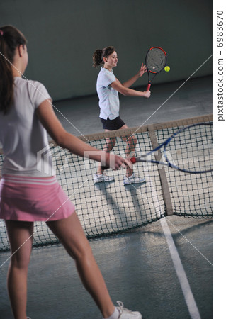 young girls playing tennis game indoor young girls playing tennis game indoor 6983670