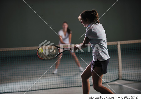 young girls playing tennis game indoor young girls playing tennis game indoor 6983672
