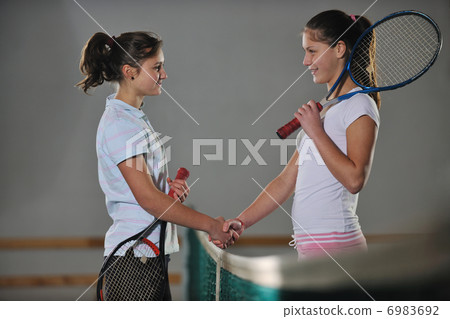 young girls playing tennis game indoor young girls playing tennis game indoor 6983692