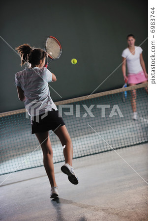 young girls playing tennis game indoor young girls playing tennis game indoor 6983744