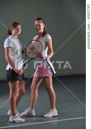 young girls playing tennis game indoor young girls playing tennis game indoor 6983745