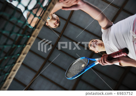 young girls playing tennis game indoor 6983752
