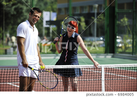 happy young couple play tennis game outdoor happy young couple play tennis game outdoor 6984005