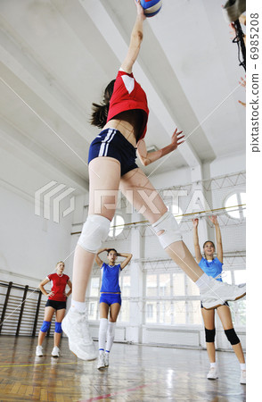 girls playing volleyball indoor game 6985208