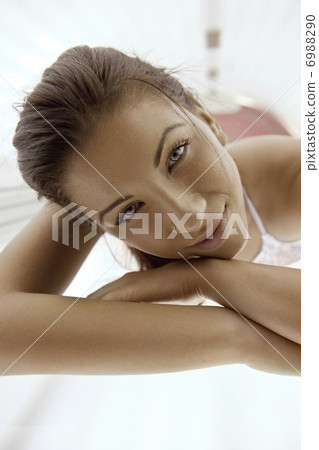 Beautiful young woman tanning in solarium Beautiful young woman tanning in solarium 6988290