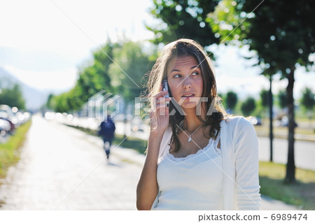 young woman talk by cellphone on street young woman talk by cellphone on street 6989474