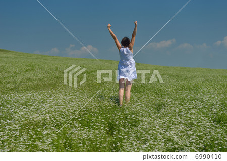 Young happy woman in green field 6990410