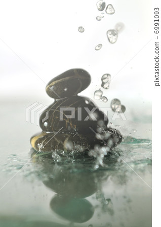 isolated wet zen stones with splashing water drops isolated wet zen stones with splashing water drops 6991093