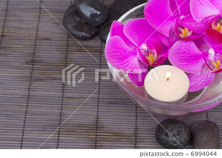 orchids with candle and massage stones orchids with candle and massage stones 6994044