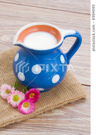 milk on wooden table 6994095