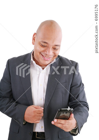 Portrait of an African American businessman text messaging 6995176