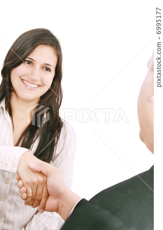 Closeup of business people shaking hands over a deal at office - 6995177