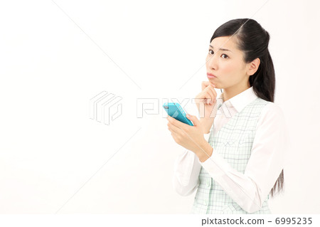 A woman watching a smartphone (worried) A woman watching a smartphone (worried) 6995235