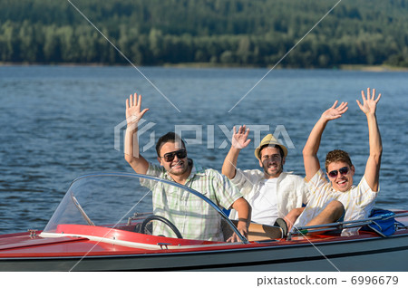 Cheerful young guys partying in speed boat 6996679