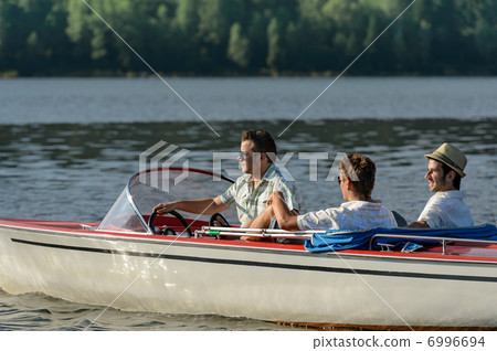 Men driving speed boat enjoying sunshine Men driving speed boat enjoying sunshine 6996694