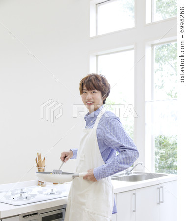 A man turning around with a frying pan A man turning around with a frying pan 6998268