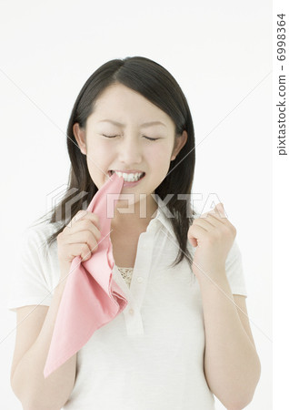 A young woman biting a handkerchief A young woman biting a handkerchief 6998364