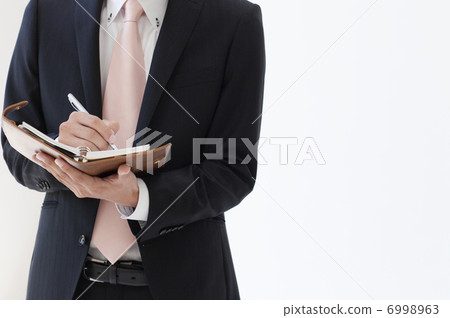 Hand with a notebook 6998963