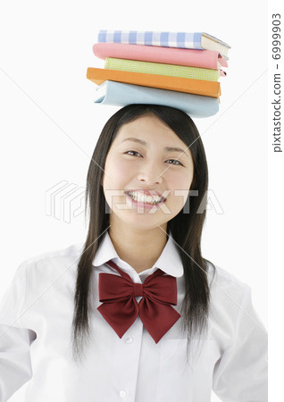 School girls who put a book on their head School girls who put a book on their head 6999903