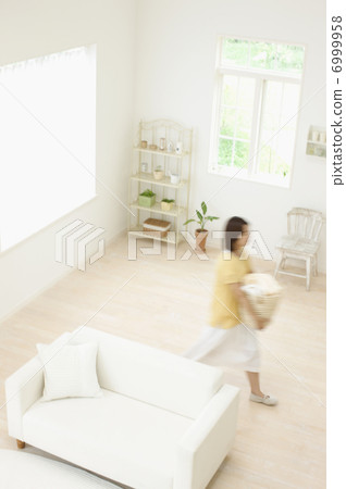 A woman walking in the room A woman walking in the room 6999958