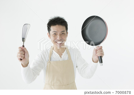 Men with cooking utensils in both hands 7000878