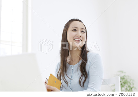 A woman smiling in front of a laptop A woman smiling in front of a laptop 7003138