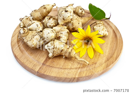 Jerusalem artichoke with a yellow flower on a round board Jerusalem artichoke with a yellow flower on a round board 7007178