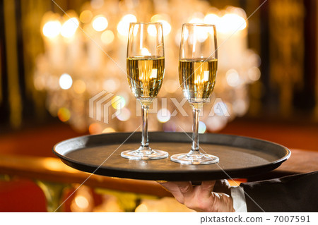 Waiter served champagne glasses on tray in restaurant Waiter served champagne glasses on tray in restaurant 7007591