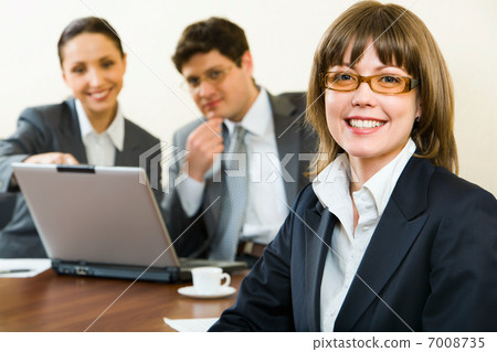 Smart woman on a background the colleagues in the office 7008735
