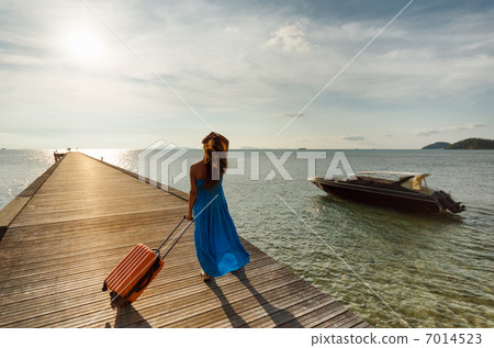 Young woman with suitcase on the pier 7014523
