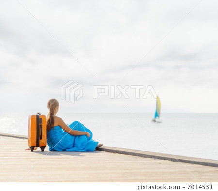 Young woman sitting on wooden pier Young woman sitting on wooden pier 7014531