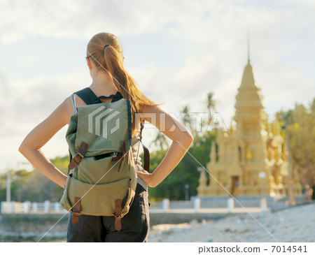 Young woman looking at golden pagoda. Hiking at Asia Young woman looking at golden pagoda. Hiking at Asia 7014541