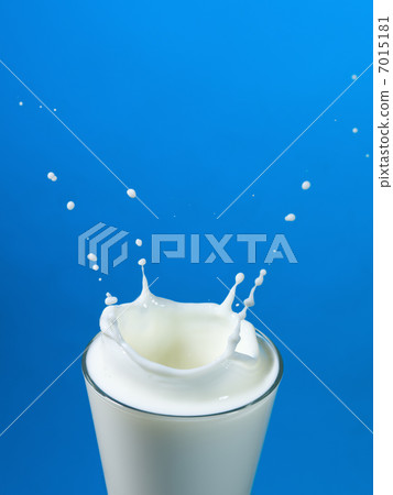 pouring milk in a glass isolated 7015181