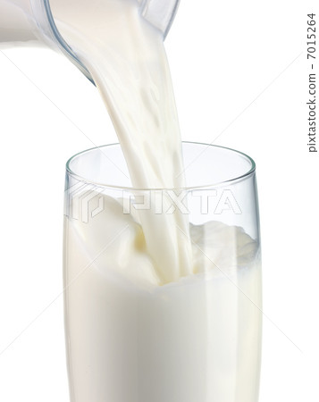 pouring milk in a glass isolated pouring milk in a glass isolated 7015264